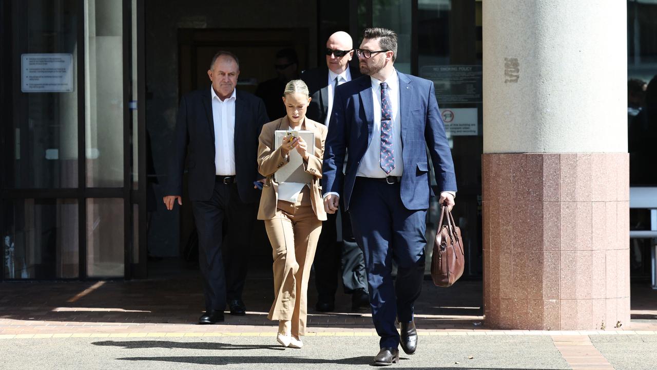 Mount Garnet police officer Sergeant Lee Adam Golding (back, with sunglasses) with members of his legal team after pleading not guilty to assault occasioning bodily harm. He was later found guilty of the charge by a jury and sentenced to 18 months jail. Picture: Brendan Radke
