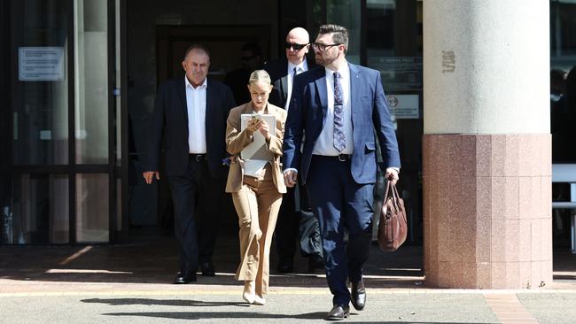 Mount Garnet police officer Sergeant Lee Adam Golding (back, with sunglasses) with members of his legal team after pleading not guilty to assault occasioning bodily harm. He was later found guilty of the charge by a jury and sentenced to 18 months jail. Picture: Brendan Radke