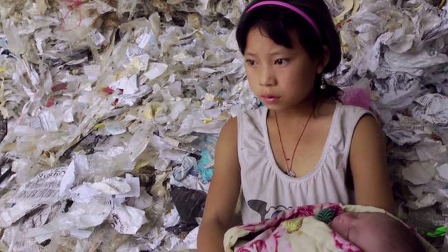 Yi-Jie, 11, dreams of leaving the plastic behind and attending school.