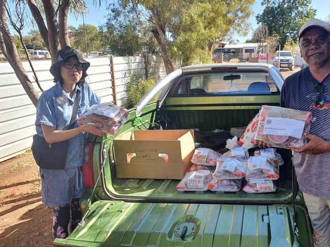 Warren H Williams and partner Louise Lam helping out with food donations