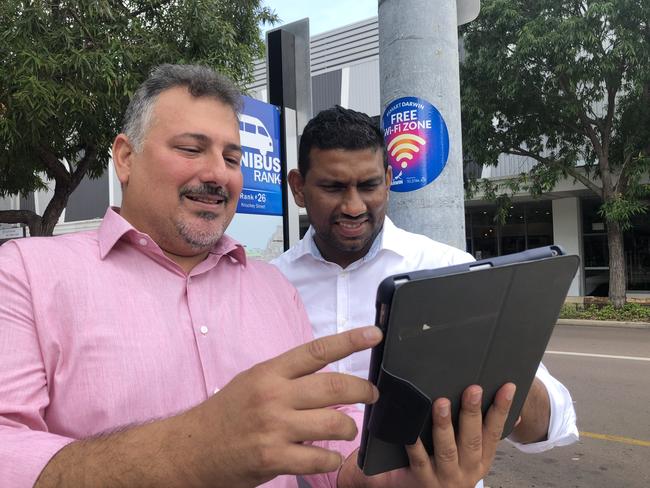 Darwin acting lord mayor George Lambrinidis and Digital Innovation manager Krishna Maheson log onto the new free Wi-Fi on Knuckey St. Picture: Will Zwar