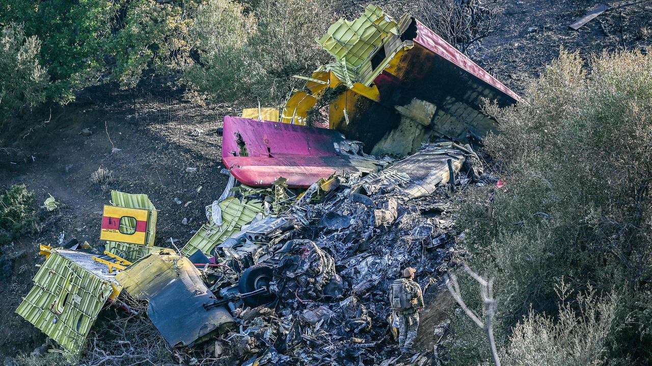 Military officers and firemen search for the debris of a Canadair CL-215 firefighting aircraft, which crashed near while being flown to fight a wildfire in Karystos, on the Greek Aegean island of Evia, on July 25, 2023. Picture: AFP