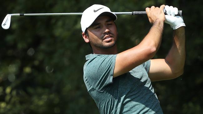 Jason Day of Australia plays his shot from the second tee.