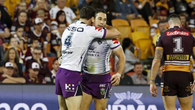 Billy Slater of the Storm celebrates with team mates after scoring a try during the Round 7 NRL match between the Brisbane Broncos and the Melbourne Storm at Suncorp Stadium in Brisbane, Friday, April 20, 2018. (AAP Image/Glenn Hunt) NO ARCHIVING, EDITORIAL USE