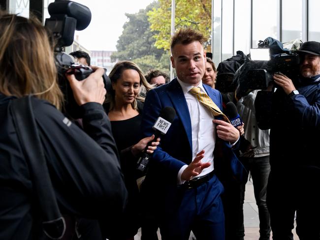 Former Seven network Spotlight producer Taylor Auerbach (centre) departs the Federal Court of Australia in Sydney, Friday, April 5, 2024. AAP Image/Bianca De Marchi)