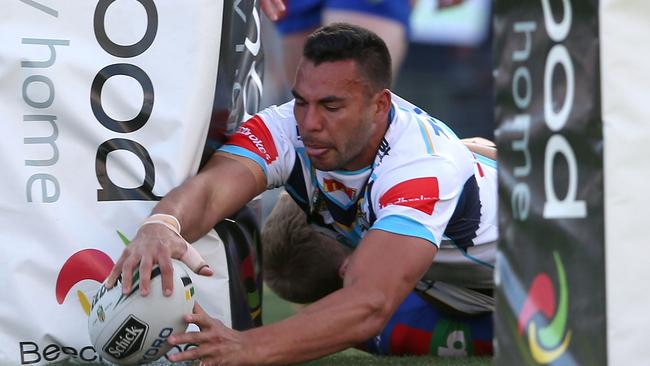 Ryan James of the Titans scores a try.