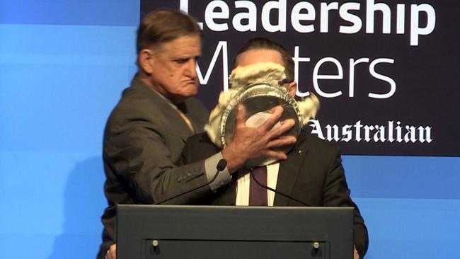 Qantas chief Alan Joyce gets a cream pie in the face from Tony Overheu while addressing a leadership breakfast at the Hyatt Regency hotel in Perth. Picture: The West Australian