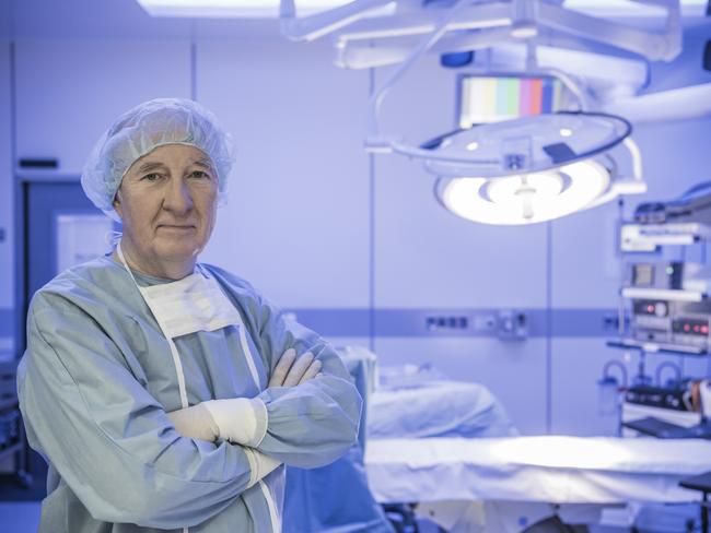 A surgeon in his gown and mask in an empty surgery. Picture sourced from iStock. ( To go with Kim Hames graphic )