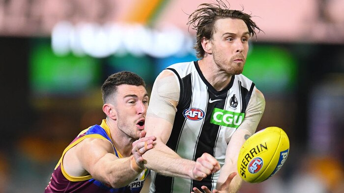 BRISBANE, AUSTRALIA - AUGUST 14: Jordan Roughead of the Magpies handballs under pressure during the round 22 AFL match between Brisbane Lions and Collingwood Magpies at The Gabba on August 14, 2021 in Brisbane, Australia. (Photo by Albert Perez/AFL Photos via Getty Images)