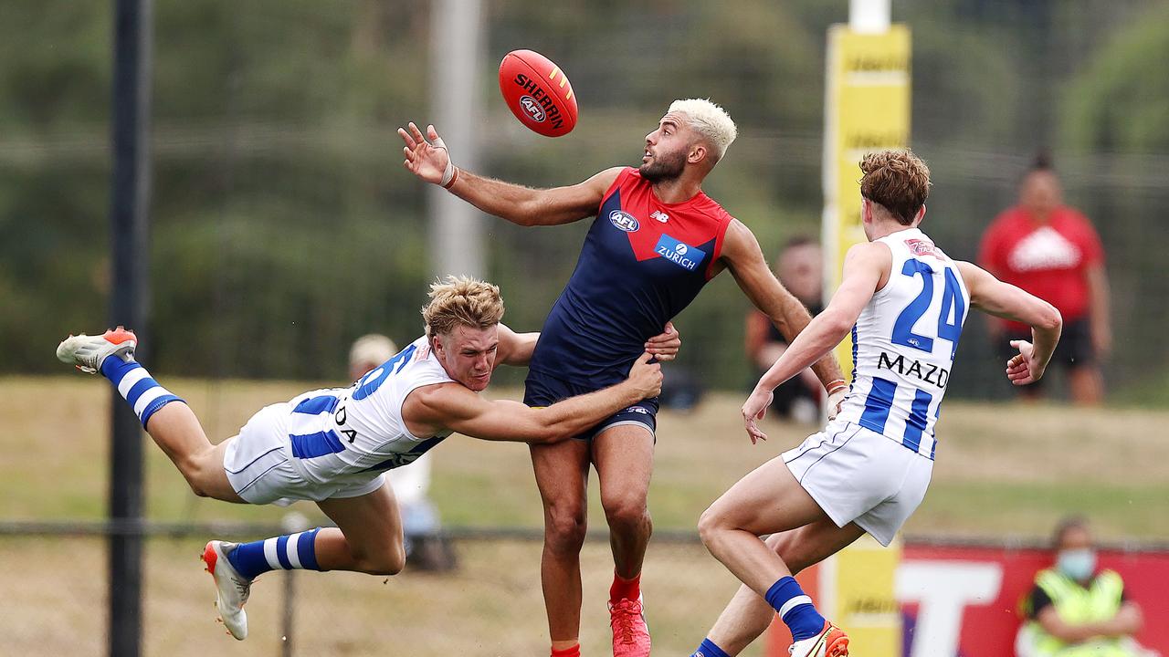 Jason Horne-Francis chases down Christian Salem to win the holding the ball free kick. Picture: Michael Klein