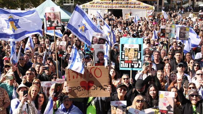 People gathered at Tel Aviv's ‘Hostages Square’ cheer as they watch on a screen the release of Israeli hostages on Saturday. Picture: Jack Guez / AFP