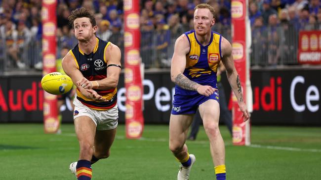 Matt Crouch handballs.