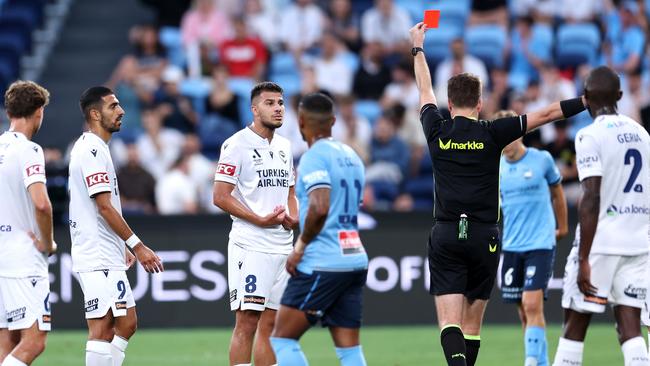 SYDNEY, AUSTRALIA - DECEMBER 28: Zinedine Machach of the Victory is shown a red card from Referee Adam Kersey during the round 10 A-League Men match between Sydney FC and Melbourne Victory at Allianz Stadium, on December 28, 2024, in Sydney, Australia. (Photo by Brendon Thorne/Getty Images)