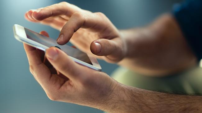 Generic Male hands typing on smartphone. Picture: Istock