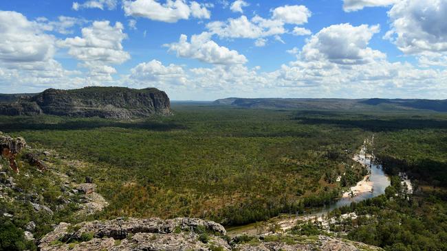 Double Falls slowly meanders down the rock face and enters the plain of the Arnhem Plateau in Kakadu National Park. Kakadu will be closed to the public from Thursday 5pm.