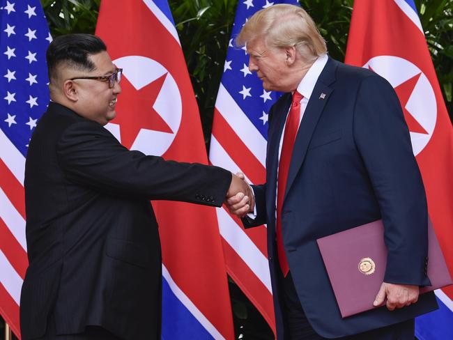 FILE - In this June 12, 2018, file photo, North Korea leader Kim Jong Un, left, and U.S. President Donald Trump shake hands at the conclusion of their meetings at the Capella resort on Sentosa Island in Singapore. The series of photos on the front page of the ruling workersâ€™ party newspaper showed something North Koreans never would have imagined just months ago, their leader Kim Jong Un warmly shaking hands with President Donald Trump. (AP Photo/Susan Walsh, Pool, Fie)