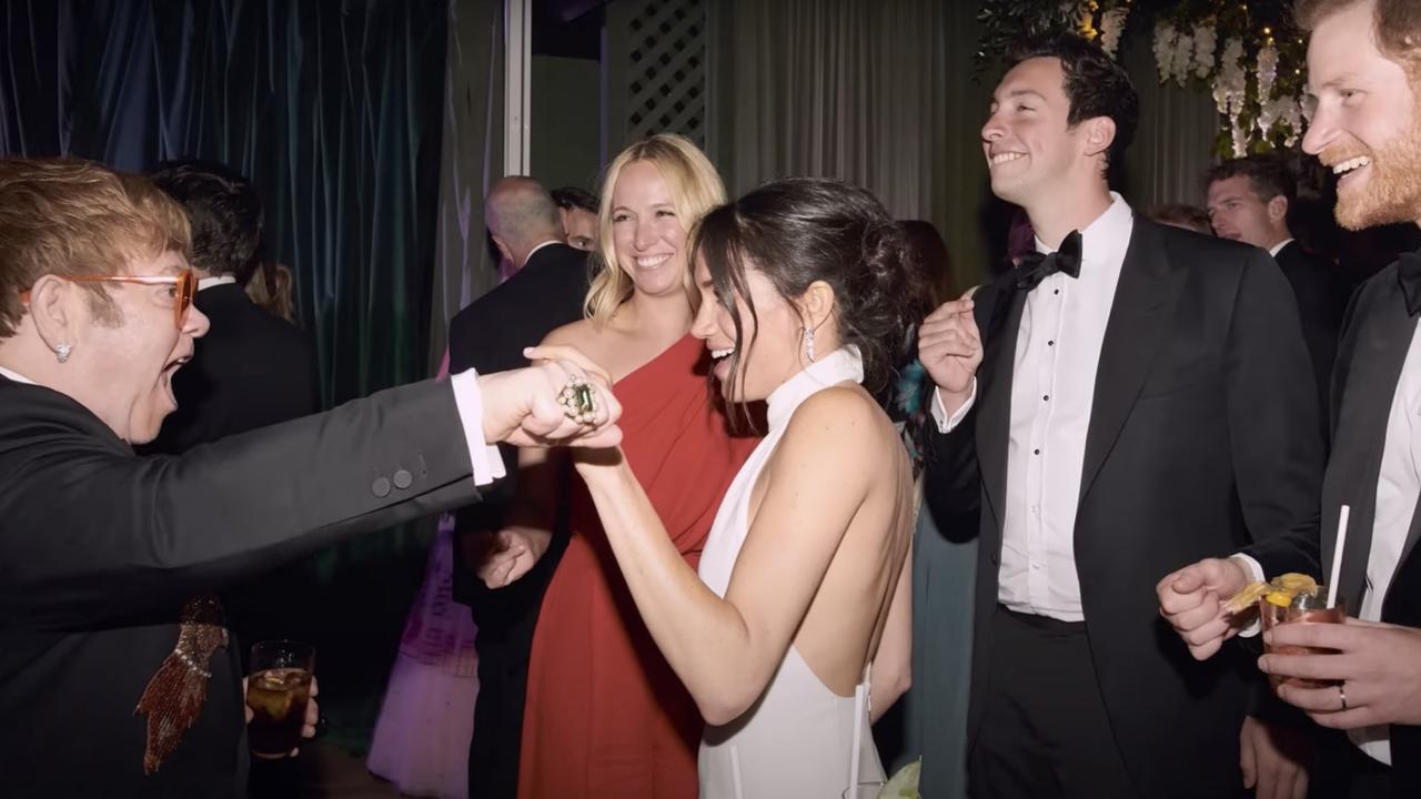 Misha Nonoo, in red, and oil tycoon Mikey Heiss party with Sir Elton John at the Sussexes’ wedding reception. Picture: Netflix