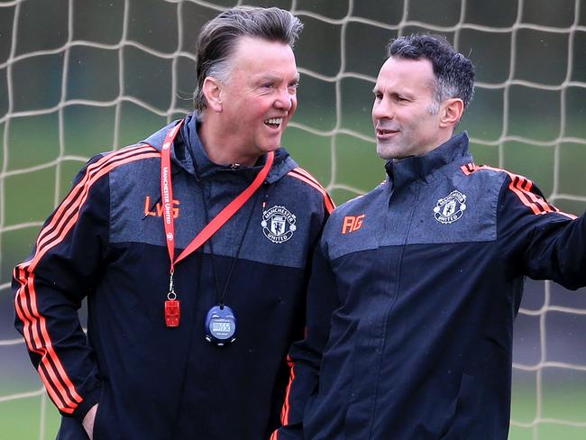 Manchester United manager Louis van Gaal and assistant manager Ryan Giggs share a joke during a training session.