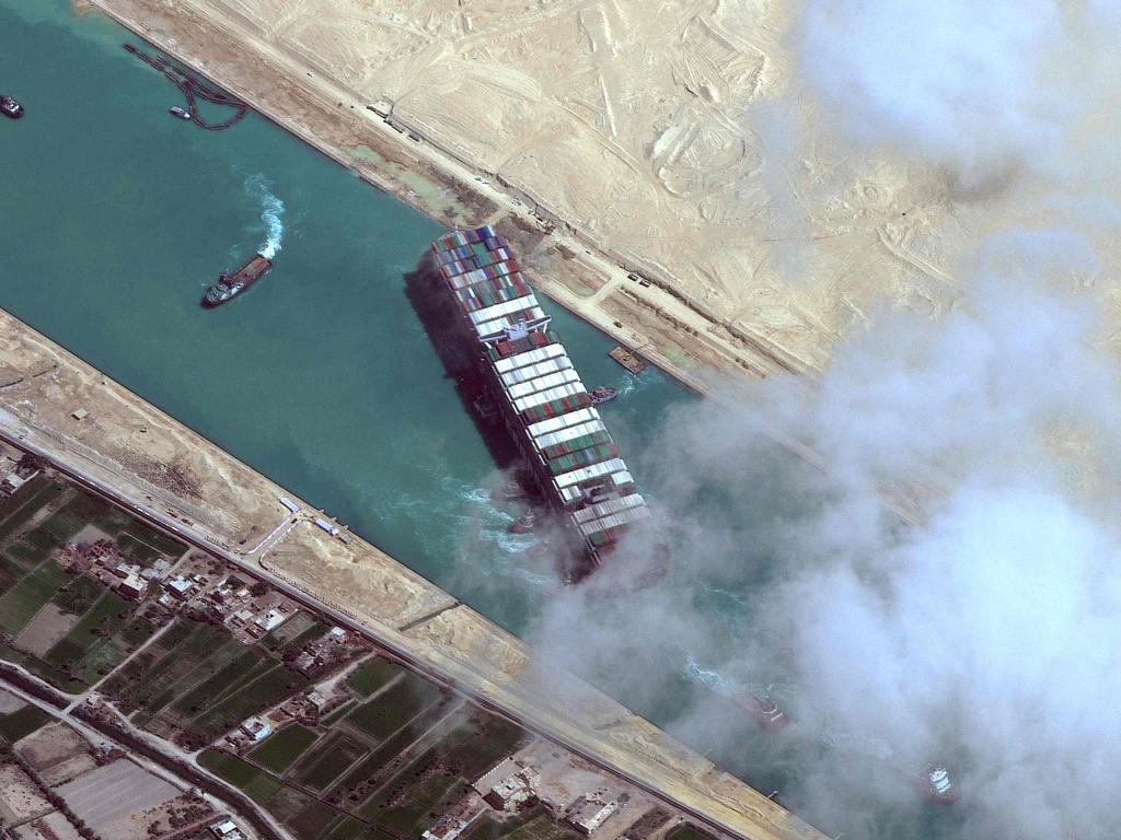 This satellite imagery released by Maxar Technologies shows an overview of the MV Ever Given container ship and tugboats in the Suez Canal on March 29, 2021. Picture: Maxar Technologies / AFP