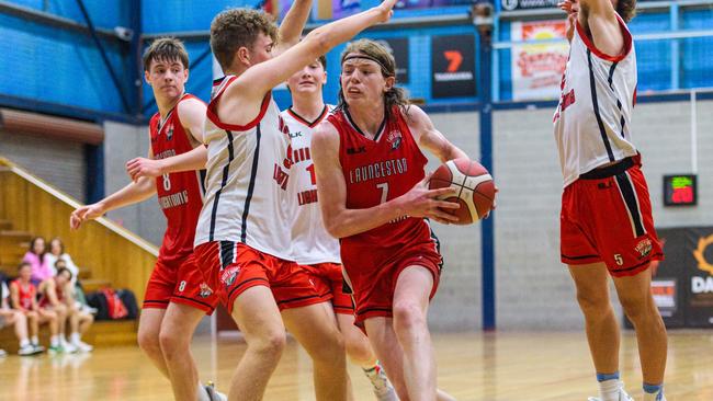 Logan Gibson of Launceston Lightning Red drives against Launceston Lightning Black in the under-18s.