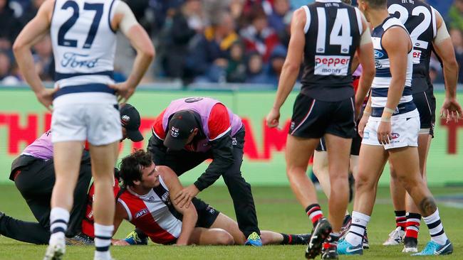 Dylan Roberton collapses against Geelong. (Photo by Darrian Traynor/Getty Images)