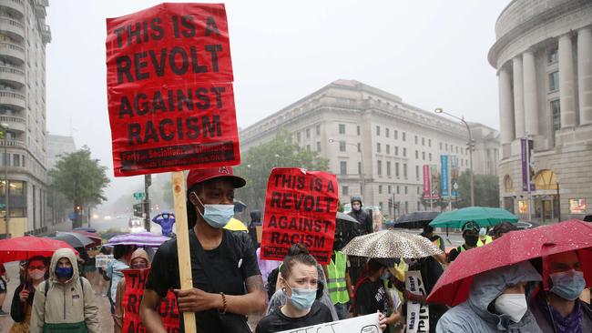 Demonstrators march in the rain during a peaceful protest against police brutality on June 5, 2020 in Washington, DC.