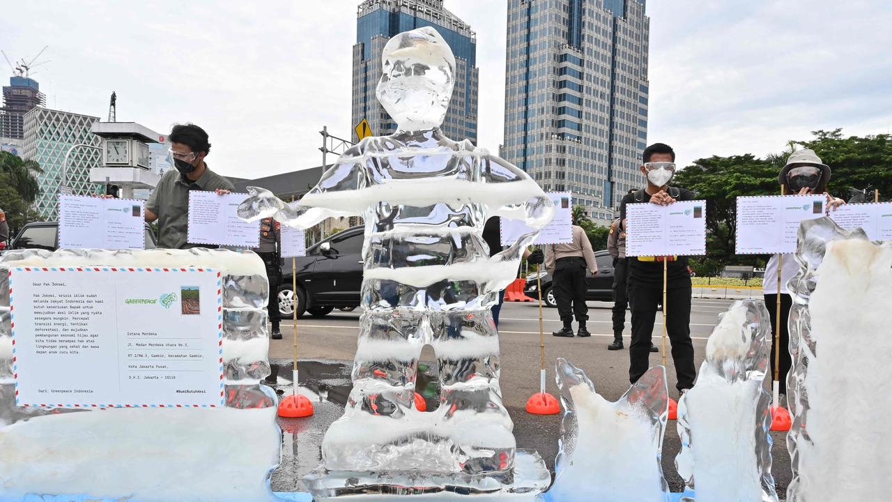 Activists from Greenpeace Indonesia take part in a rally with an ice-made effigy and postcards to Indonesian President Joko Widodo calling for action on climate change in Jakarta. Picture: Adek Berry/ AFP