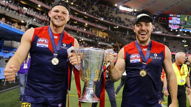 PERTH, AUSTRALIA - SEPTEMBER 25: Steven May of the Demons and Michael Hibberd of the Demons celebrate with the premiership cup during the 2021 Toyota AFL Grand Final match between the Melbourne Demons and the Western Bulldogs at Optus Stadium on September 25, 2021 in Perth, Australia. (Photo by Dylan Burns/AFL Photos via Getty Images)