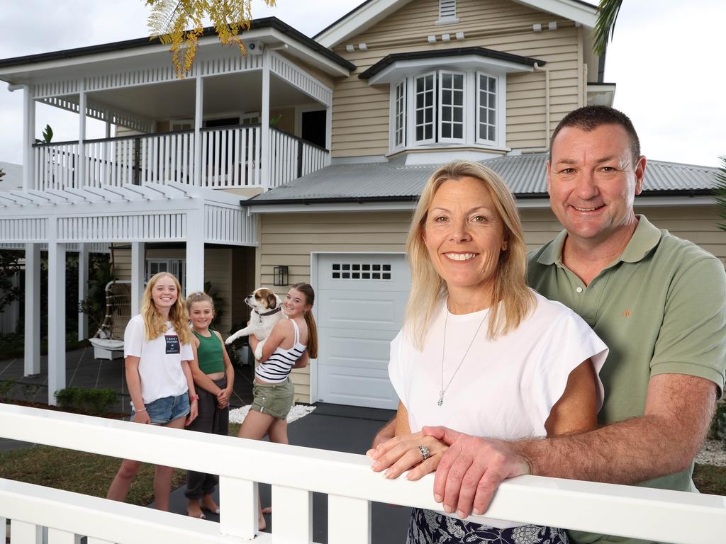 Troy and Sally McMillan with their kids Tayla, 15, Siena, 13, and Bella, 11, at their Kedron home they are selling. Picture: Liam Kidston