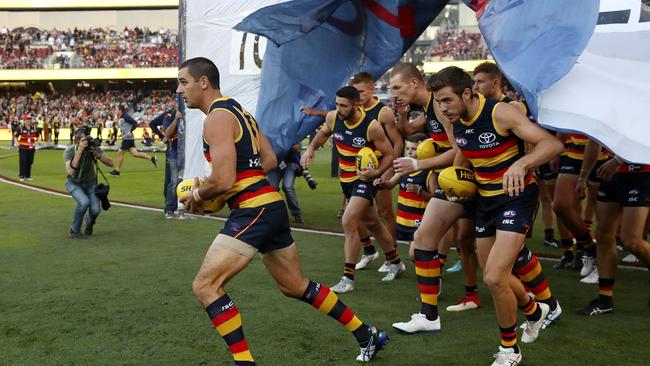 Walker leads the team out onto Adelaide Oval. Picture SARAH REED