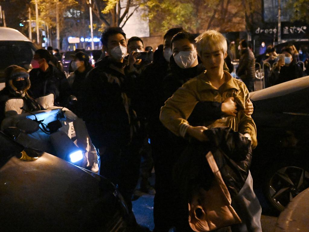 A protester scuffles with police in Beijing. Picture: AFP