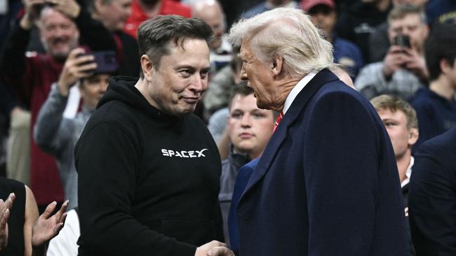 Musk and Trump shake hands as they attend the men's NCAA wrestling competition in March. Picture: AFP