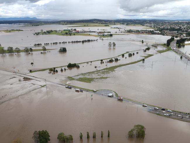 NSW Rescue workers searching for two people swept away in a car from the causeway on Cessnock Road, Maitland today. Picture: Adam Taylor