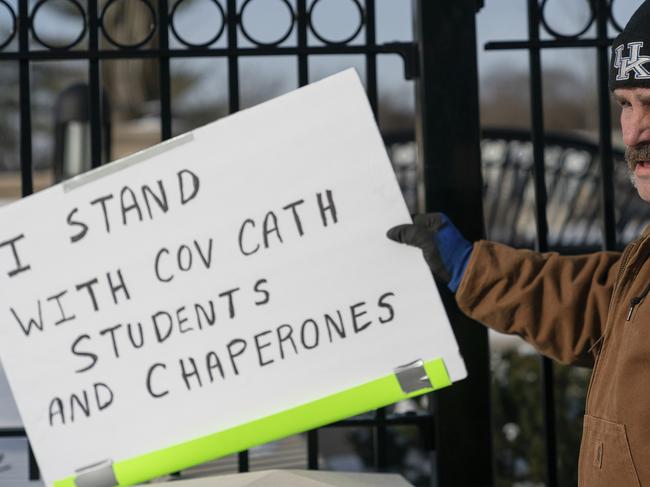 A man places a sign showing support for the students of Covington Catholic Catholic High School. Picture: AP