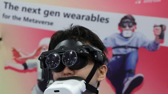 Tomohiko Fukaya demonstrates Shiftall’s full-body tracking device, including the mutalk Bluetooth microphone over his mouth and the MeganeX VRE headset with an HDR micro OLED display, for playing VR in the metaverse during a press event at CES 2023 at the Mandalay Bay Convention Center on January 03, 2023 in Las Vegas, Nevada. Ethan Miller/Getty Images/AFP (Photo by Ethan Miller / GETTY IMAGES NORTH AMERICA / Getty Images via AFP)