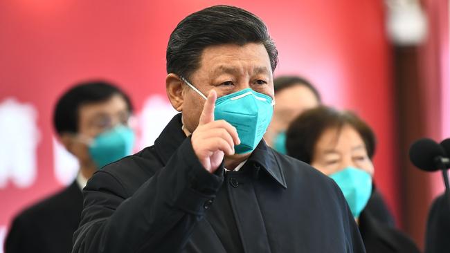 Chinese President Xi Jinping wearing a mask as he gestures to a coronavirus patient and medical staff via a video link at the Huoshenshan hospital in Wuhan, in China's central Hubei province this week Picture: AFP