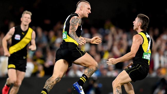 Dustin Martin storms off in celebration after one of his four goals.