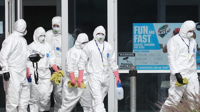 Cleaners at Mawson Lakes Primary School in Adelaide’s north on Monday after it was linked to the latest outbreak. Picture: Tait Schmaal