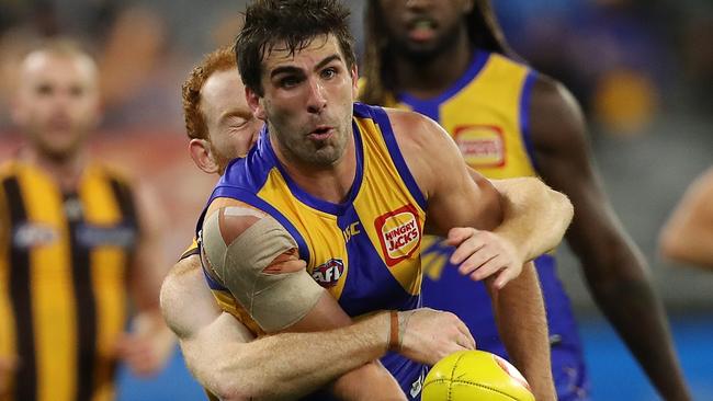 PERTH, AUSTRALIA - AUGUST 16: Andrew Gaff of the Eagles looks to handball while being tackled by Conor Glass of the Hawks during the round 12 AFL match between the West Coast Eagles and the Hawthorn Hawks at Optus Stadium on August 16, 2020 in Perth, Australia. (Photo by Paul Kane/Getty Images)