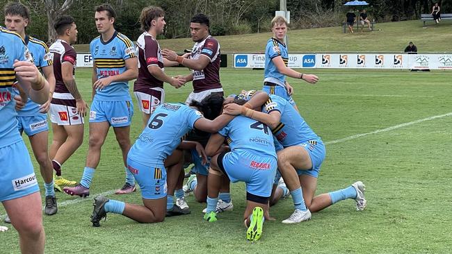 Norths Devils Meninga Cup players pray after the win.