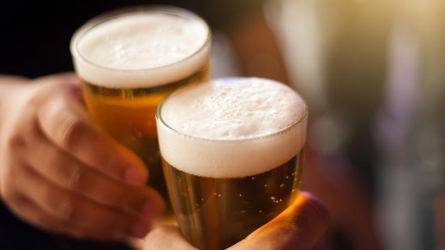 Cheers! Clink glasses. Close-up shots of hands holding beer glasses and beer bubbles.