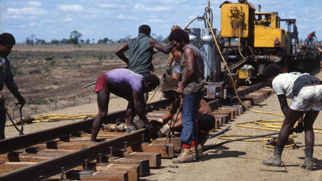 Fettlers laying track on the Gregory Line, Central Queensland, 1980. It was through railway work a lot of Aboriginal families met Torres Strait Islander and South Sea islander men, who were also working as fettlers, and a lot of marriages occurred. “These people are our people too,” Ms Ault said. “Our homes are for any First Nations people, not just a certain group”. (Image From The Workshops Rail Museum Queensland Rail Collection).