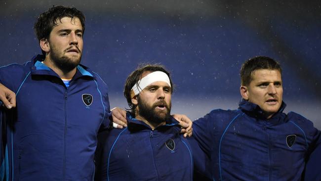 Ignacio Dotti, Federico Favaro and Leandro Leivas of Uruguay sing the national anthem.