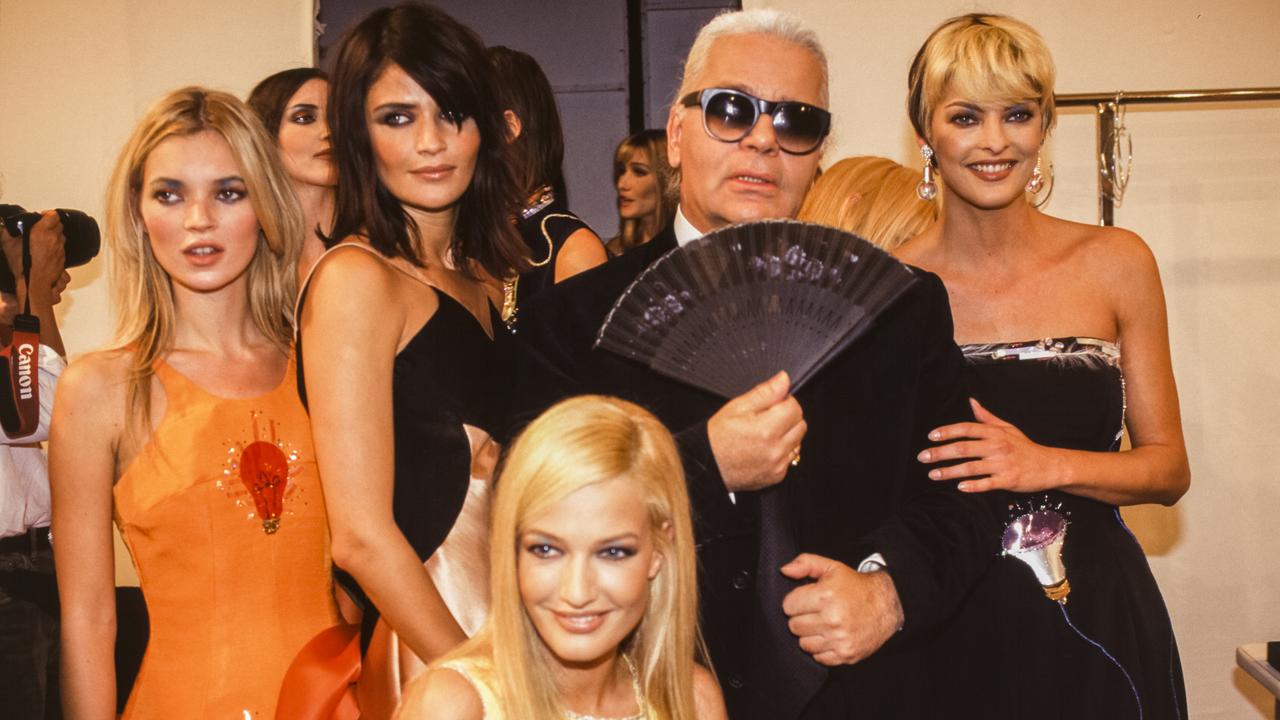 Kate Moss, Helena Christensen, Karen Mulder and Linda Evangelista (right) with Chanel designer Karl Lagerfeld in 1995. Picture: WILLIAM STEVENS/Gamma-Rapho via Getty Images.