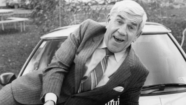 1981? Lou Richards on the bonnet of a car painted with Collingwood magpie logo.