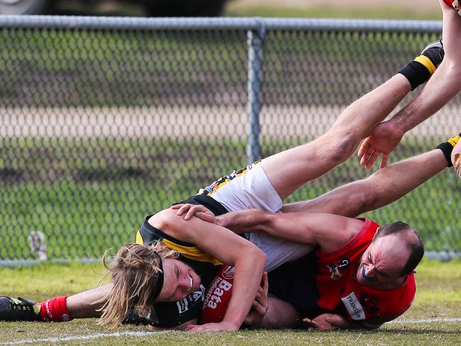 Damien Kent (right) burrows in for Mt Eliza.