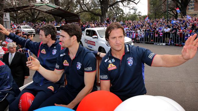 Bob Murphy, Easton Wood and Coach Luke Beveridge enjoy the atmosphere during the 2016 Grand Final Parade in Melbourne.