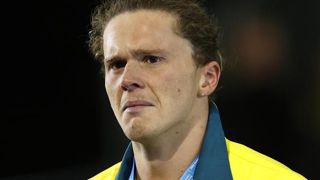 Devastated silver medallist Isaac Cooper shows his emotion during the medal ceremony for men’s 50m backstroke final at Melbourne Sports and Aquatic Centre.