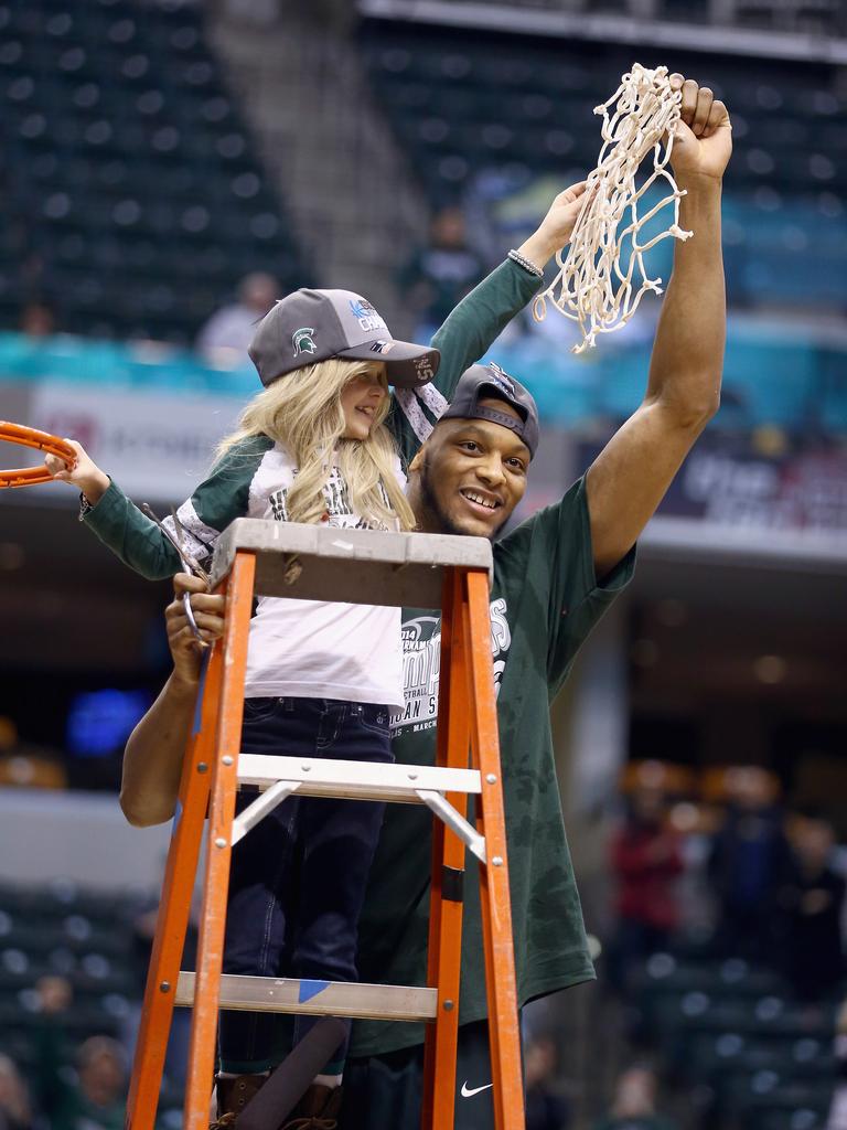 Adreian Payne celebrates with 8 year old Lacey Hullsworth after the 69-55 win over the Michigan Wolverines during the finals of the Big Ten Basketball Tournament. (Photo by Andy Lyons/Getty Images)