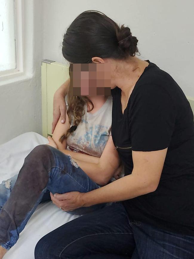 Kylie Evelyn, 14, in hospital with blood soaked jeans is comforted by a relative. Picture: Dinorah Liddiard/Facebook